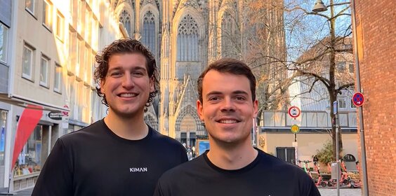 Zwei Männer stehen zusammen vor dem Kölner Dom.