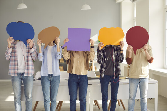 Group of people holding empty colorful speech balloons for your message or opinion