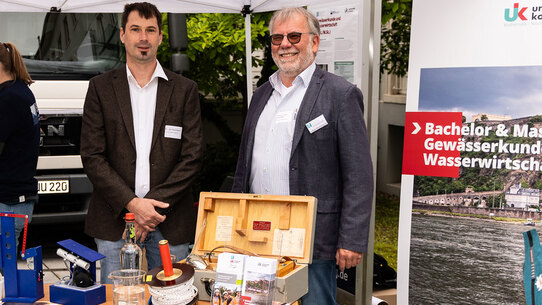 Zwei Männer stehen an einem Stand